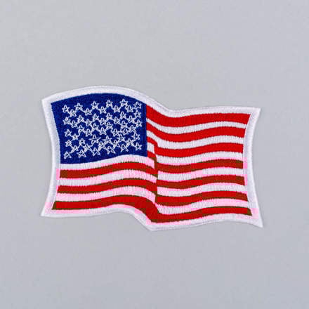Embroidered Wavy American Flag Patch with white border laid flat
