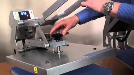 Close up of person adjusting a Hotronix Hover Heat Press's knob