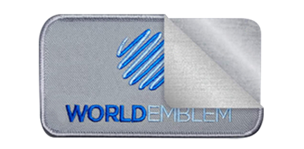 World Emblem patch with the application layers pulled back to show the patch, and heat seal strip below